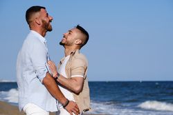 Happy gay couple enjoying and embracing outdoors