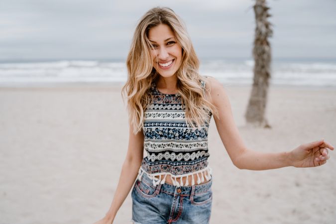 Happy female laughing on sandy beach