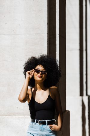 Cheerful Black female in dark sunglasses