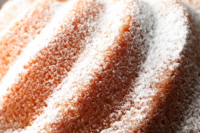 Cake with powder sugar texture on whole background, close up
