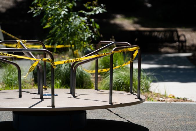 Merry-go-round with caution tape to signal closed park