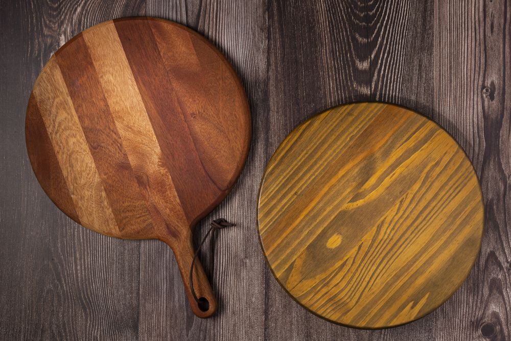 Empty pizza board on rustic wooden table. Top view image.