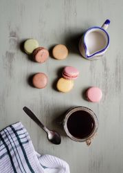 Spoon and napkin near coffee and macaroons