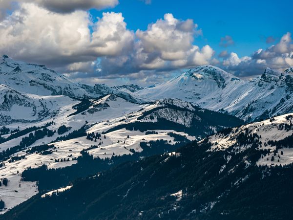 Swiss Alps winter landscape with snow and sun, mountains in Europe