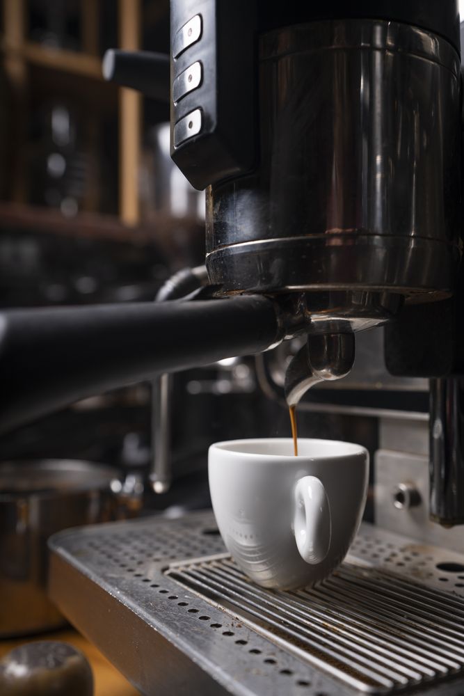 Barista making coffee using a coffee maker