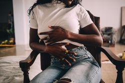 Black woman holding her stomach