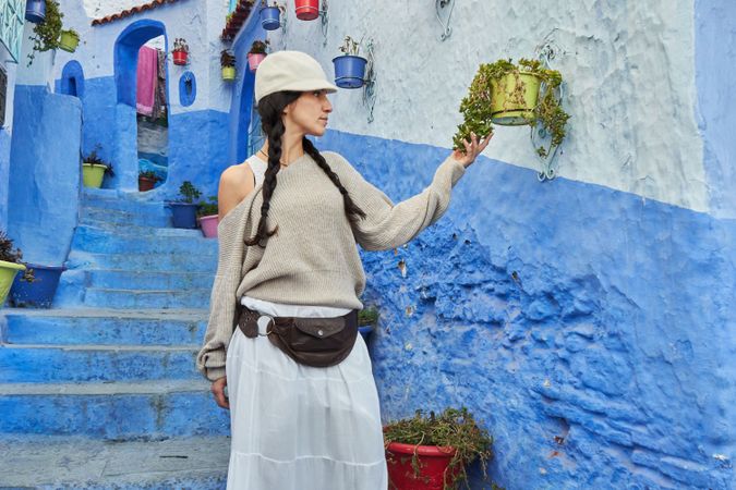 Woman on steps between ancient buildings