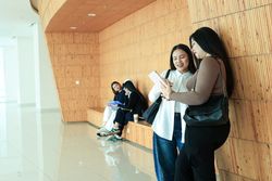 Two Group of Asian Female College Student at Campuss Gathering Discussing doing Homework.