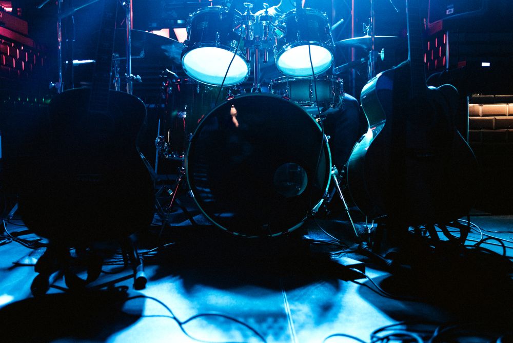 Drum set on stage in blue neon spotlights