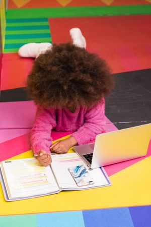 Black girl using laptop in studio