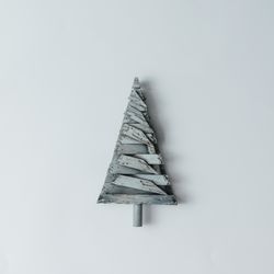 Decorative wooden Christmas tree on light background