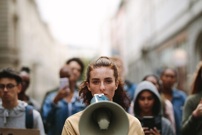 Woman protesting with megaphone in the city