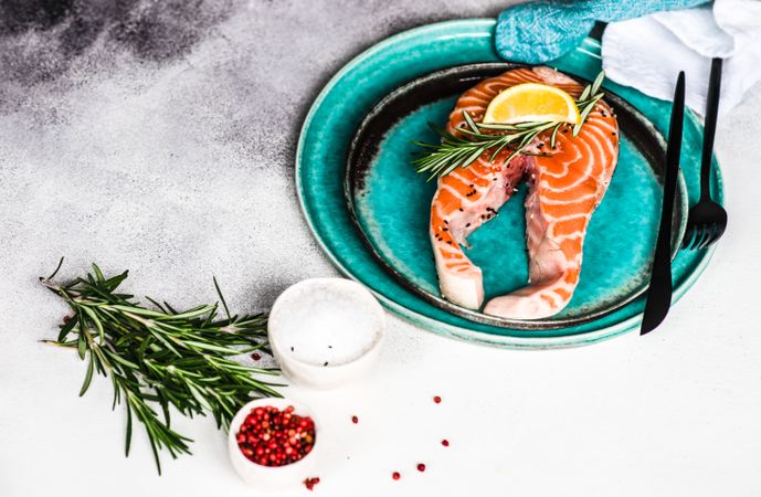 Salmon fish and seasonings on stone background with copy space