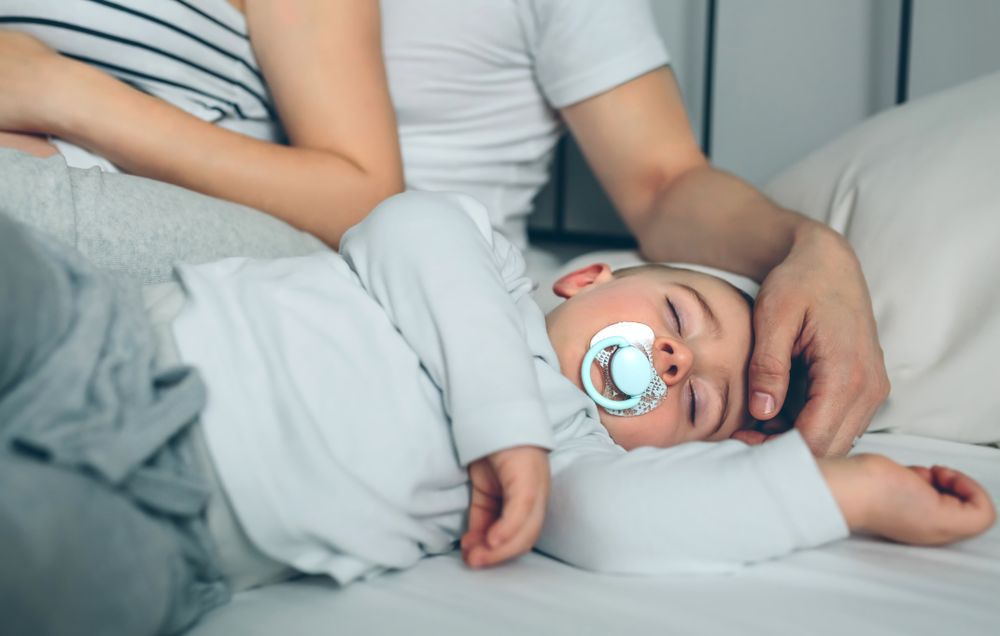 Baby asleep with loving parents