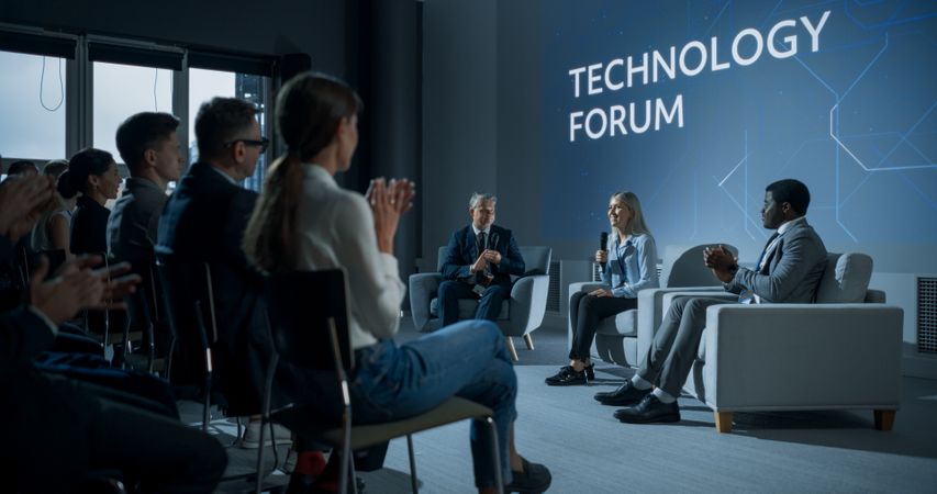 International Technology Conference: Host Asking Female Tech CEO a Question In Front Of Audience.