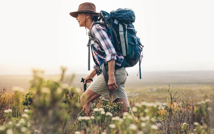 Side view of a mature woman trekking in the wild