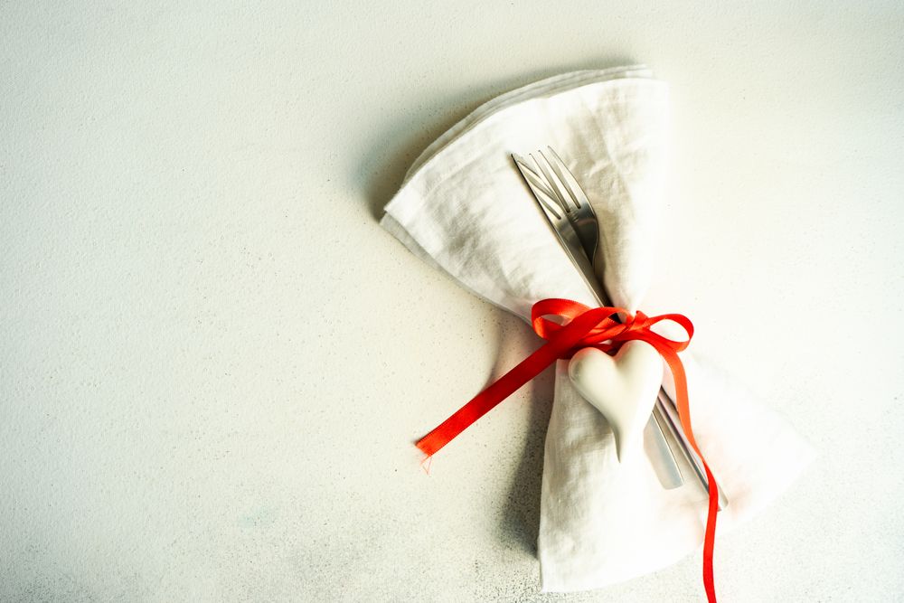 Romantic table setting with red ribbon