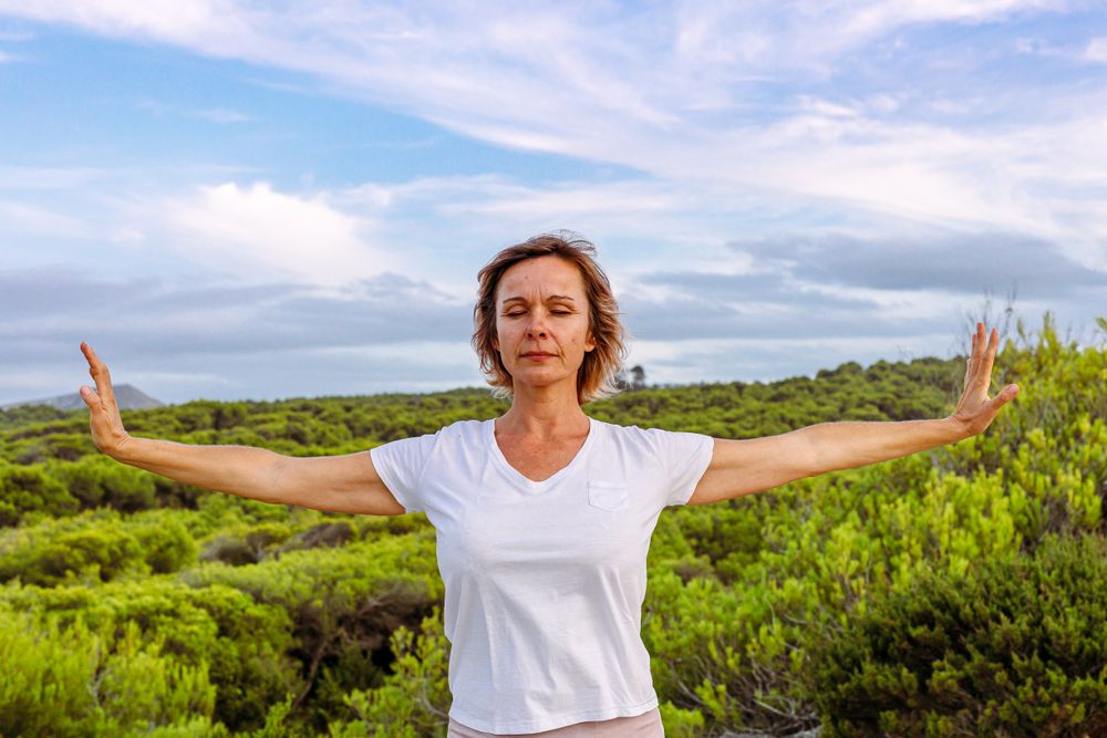 Adult woman practicing martial arts in nature