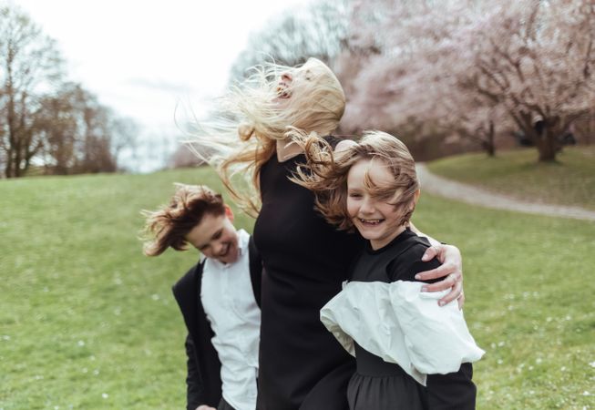 Mother and children near blooming trees