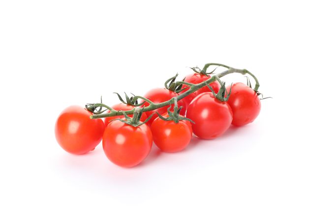 Branch of cherry tomatoes isolated on plain background