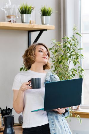 Freelancer Workplace In Kitchen With Laptop And Mug