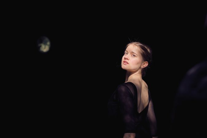 Charming ballerina in black outfit in nature