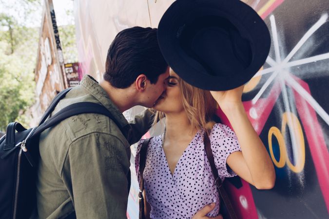 Happy couple kissing while walking in town