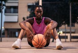 Confident female basketball player on the court