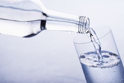 Pouring still water in a glass