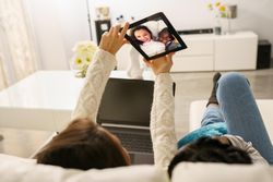 Two young women taking selfie at home