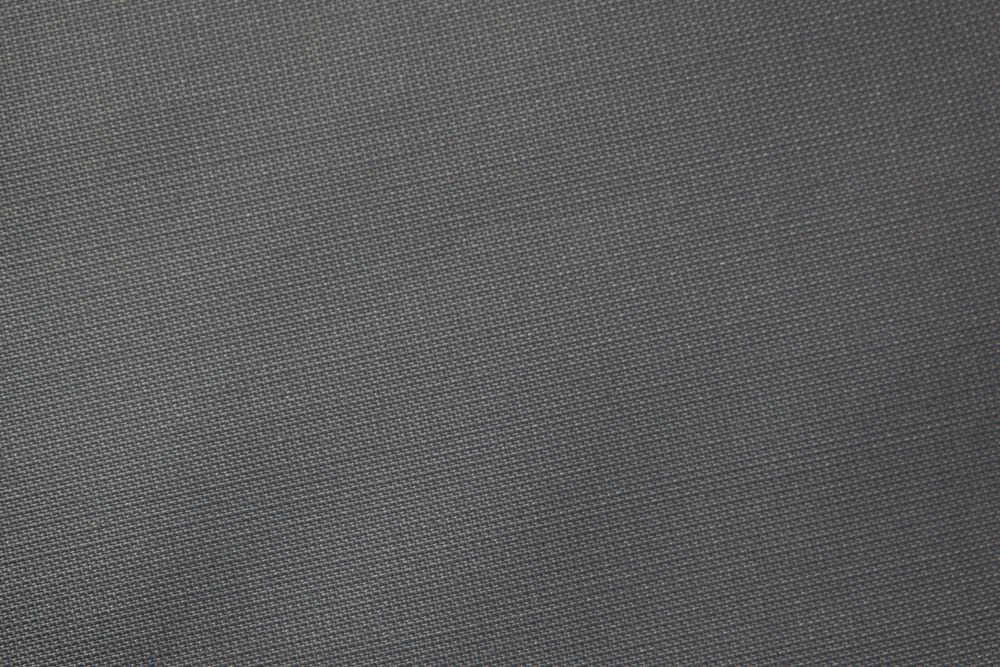 Flat view detailed dark grey silky fabric background texture.
