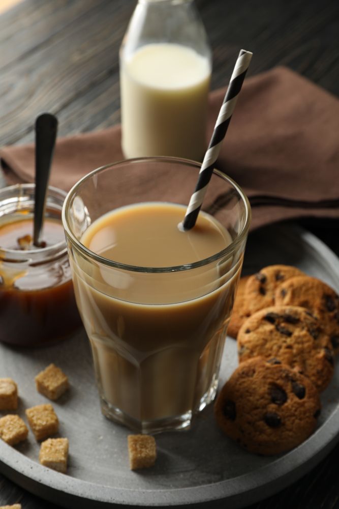 Composition with ice coffee and cookies on wooden background