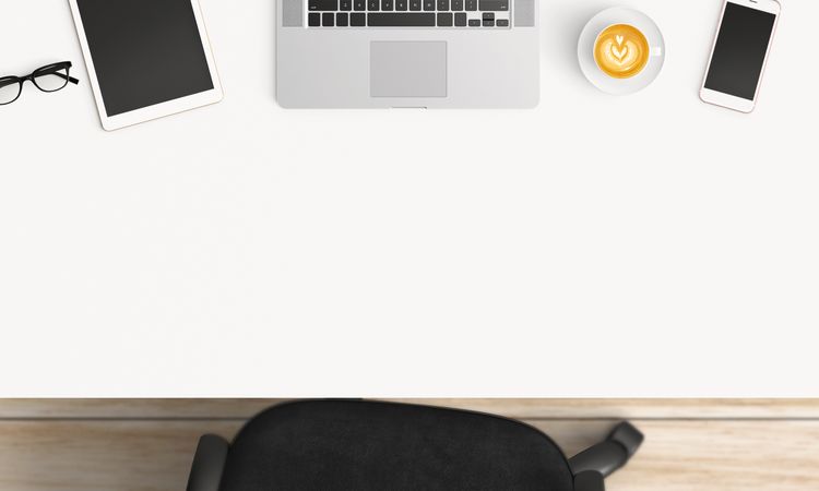 Modern workplace with coffee cup and smartphone or laptop copy space on office table background. Top view. Flat lay style
