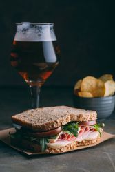 Delicious sandwich with ham, cheese, lettuce and tomato