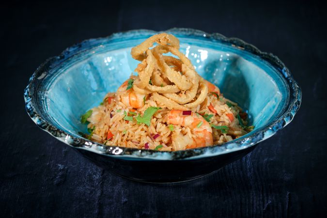 Bowl of delicious fried rice with shrimps on table