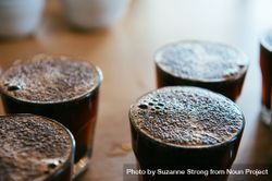 Close up shot of hot coffee in glasses lined up ready for coffee tasting 0v3LB5