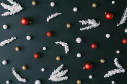 Christmas tree branches with red decorations on dark table background