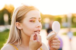 Woman does makeup on street