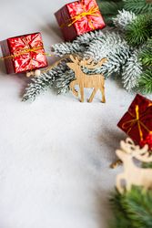 Christmas tree branch with decorative boxes and reindeer