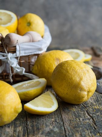 Lemons and reamer placed on wooden board