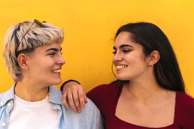 two women smiling looking each other