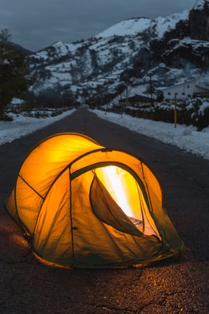 Illuminated tent in the middle of asphalt road