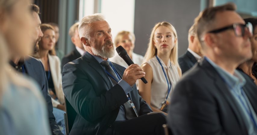 Man Listening To Keynote Presentation About New Startup Company Service.