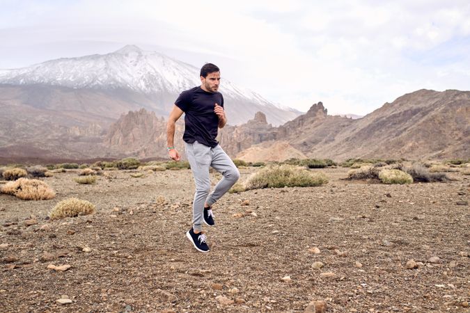 Male traveler jumping in mountains