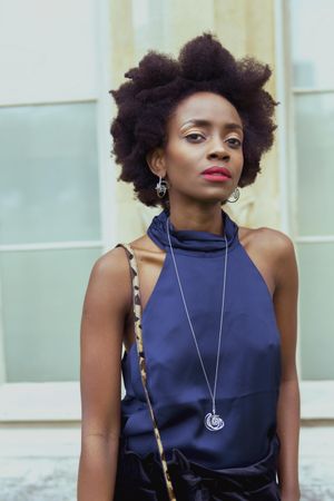 Portrait of woman with afro hair wearing blue top