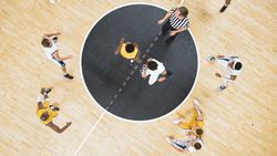 Basketball Match Cinematic Top Down View Shot: Two Multiethnic Opposing Team Players Fighting for Possession of the Ball.