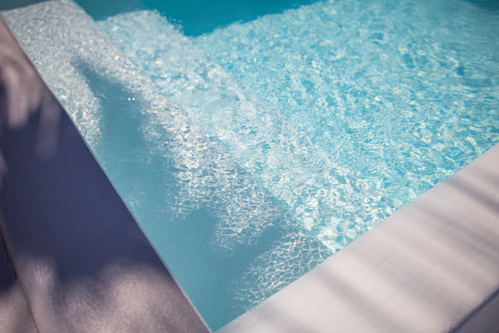 Shadow of palm trees over a pool