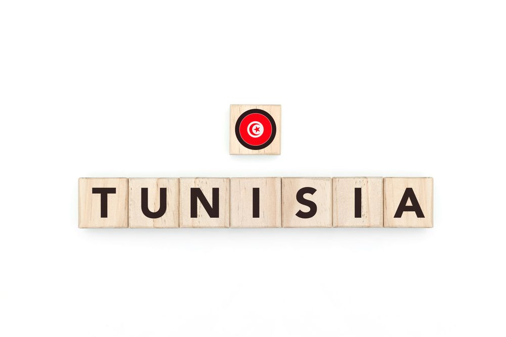 Wooden blocks bearing the name and flag of Tunisia. Tunisian and African Culture, national identity, travel, and geography in a copy space design.