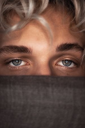 Young man's sad blue eyes