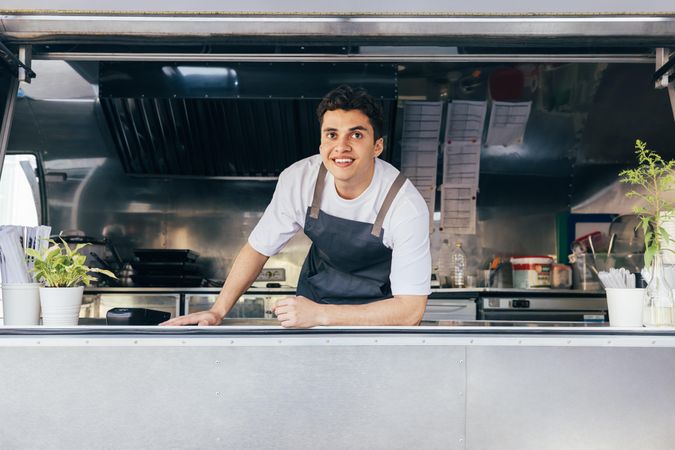 Happy food truck cook in open kitchen